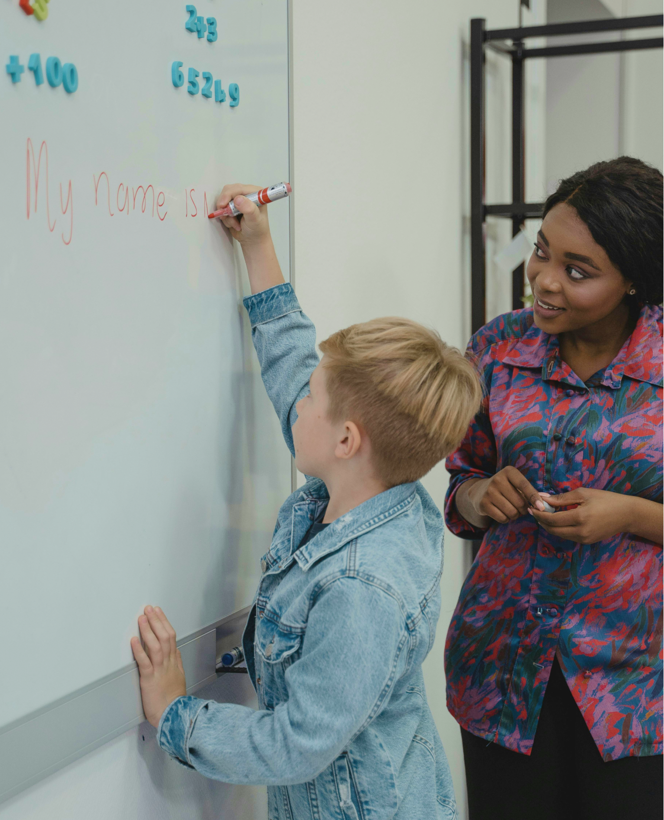 Teacher and student at a whiteboard